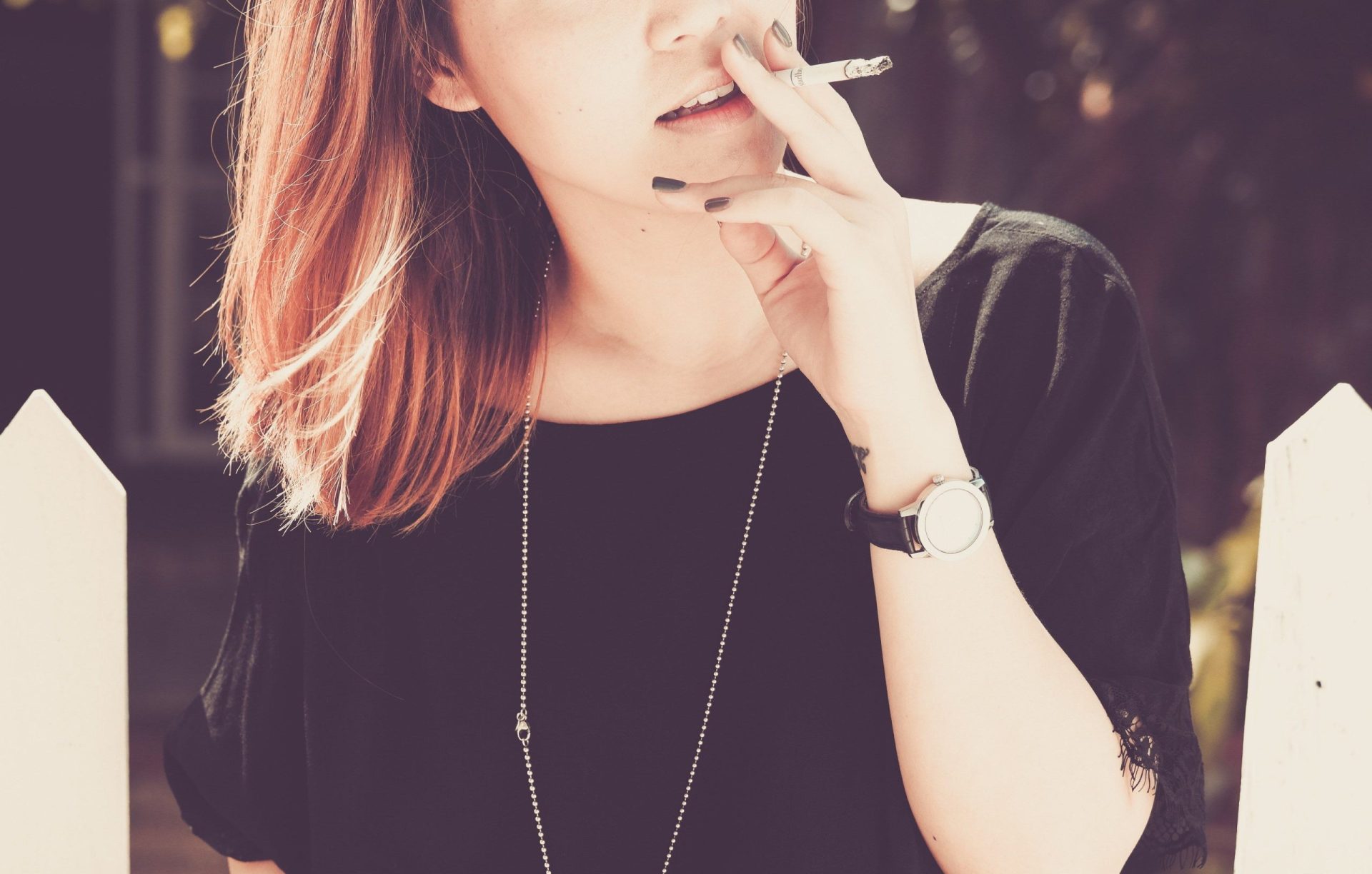 Wallpaper / young woman smoking a cigarette outside